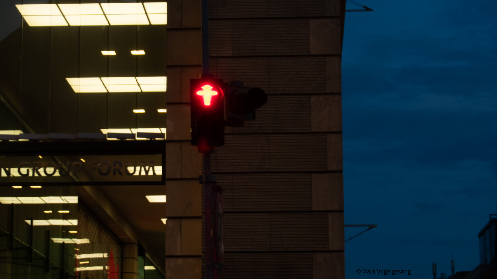 Ampelmännchen in Berlin signaling to stop at the crosswalk.